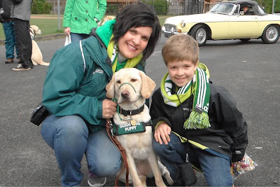 Woman and boy with yellow Lab puppy