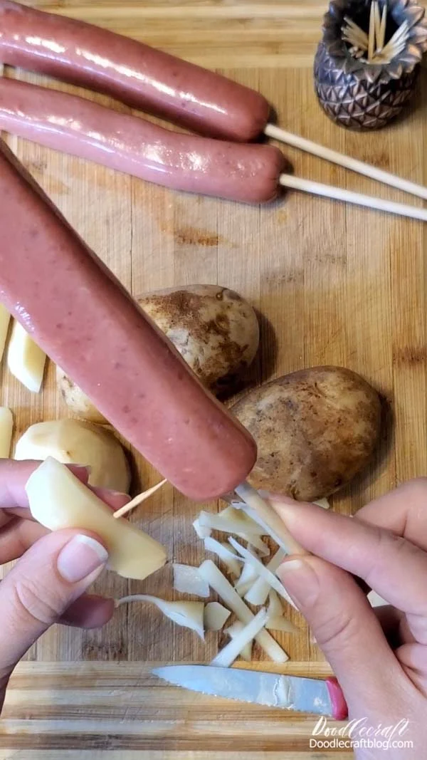 Step 3: Toothpicks  Use toothpicks cut in half to secure the potato pieces into the sausage.   Use 2 toothpicks in each potato so they don't spin around when you dip them in the batter.