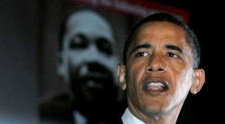 Obama speaks with MLK poster in background