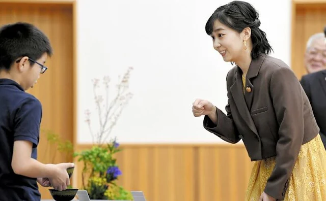 Princess Kako wore a yellow lace midi dress, and brown double-breasted short blazer. Cherry brooch and earrings
