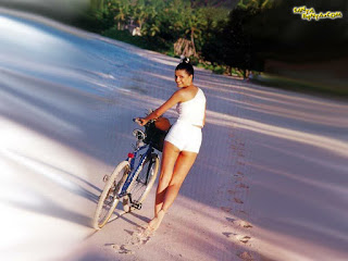 Helen Brodie Walking With Cycle On A Sand