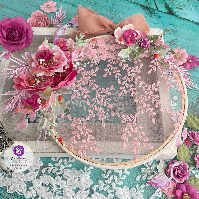 Altered embroidery hoop created with: Prima Marketing. Postcards from Paradise lace, floral ephemera, paper flowers (may flowers, aloha, blissful day), moulds, say it in crystals, Finnabair art stones, impasto paint, Art Philosophy, metallic pastel accents watercolors