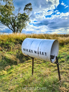 Barrell shaped Letter box with Willy Wally printed on the side