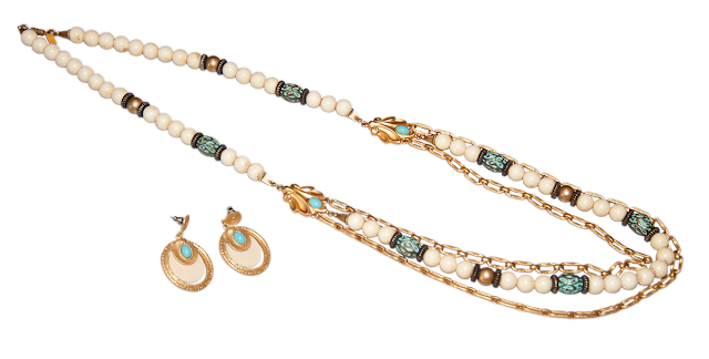 A modern necklace of white and gold beads, with long turquoise beads and gold chains. Includes a pair of matching earings.