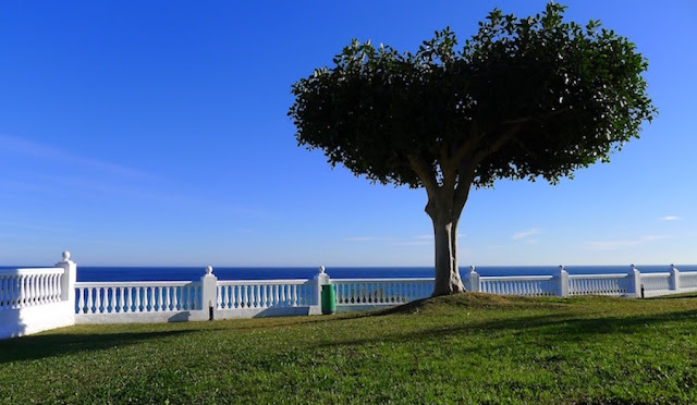 Blue sky in Nerja, Spain with calm seas.