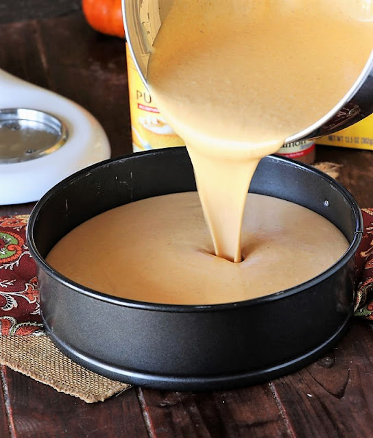 Pouring Creamy Pumpkin Cheesecake Batter into Springform Pan Image