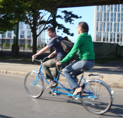 couple riding a tandem bicycle