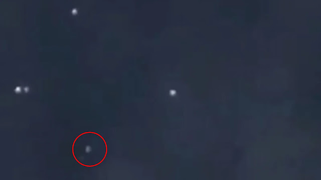 It doesn't look like much but it's a UFO sphere actually harassing a satellite in low Earth orbit.