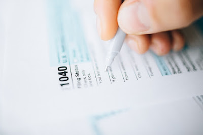 A person is filling a tax form