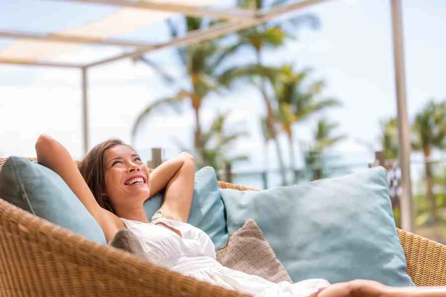 A happy woman relaxing on holiday. Stock image from Canva Pro