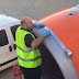 Shocked passenger snaps airport worker using tape on plane engine just moments before take-of 