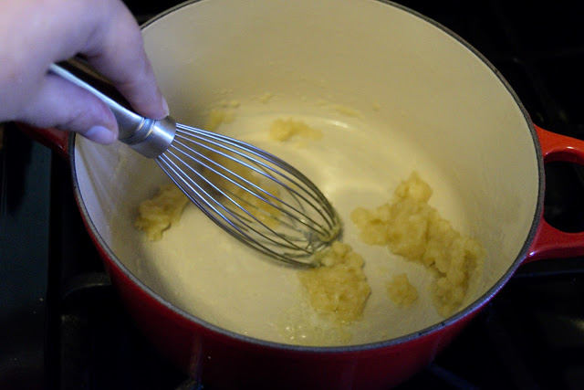 A picture of the flour and butter, in the pot, being whisked together to make a roux.