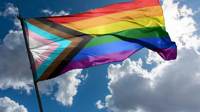 progress pride flag waving in the air