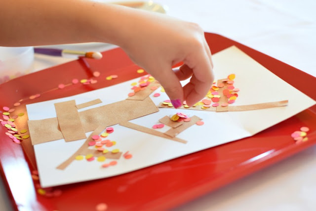 Fall tree craft for toddlers, preschoolers, or kindergartners.  Use hole punch circles in red, orange, and yellow to make autumn leaves!  Great fine motor work!