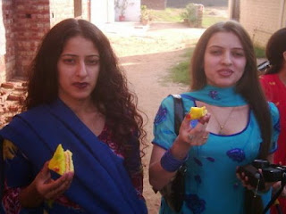 Two Sexy Aunties Eating a Cake in Street