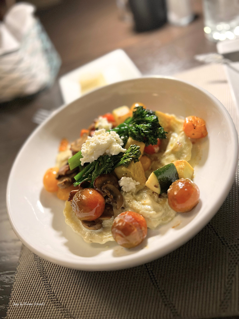 Made-from-scratch Wild Mushroom Ravioli topped with a rainbow of vegetables at 240 West.