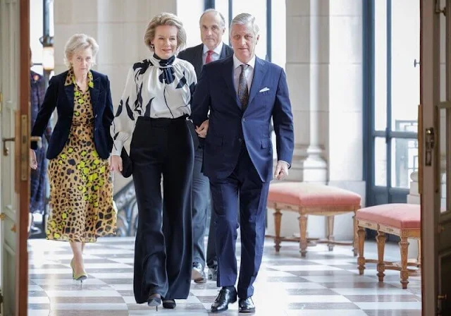 Queen Mathilde wore a new ecru Varzy blouse by Natan, and black trousers. Princess Astrid wore a printed silk dress by Gucci