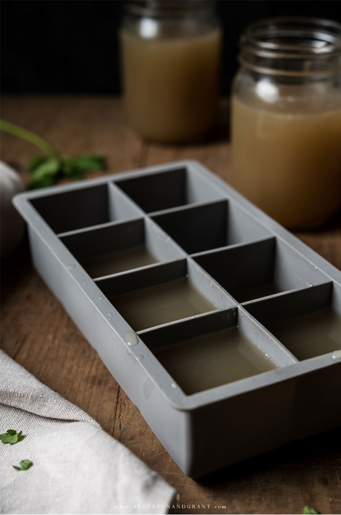 Ice cube tray filled with homemade chicken stock