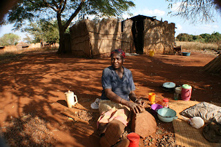 Gogo cracking marula using the traditional "big-rock/little rock" technique