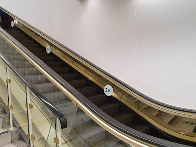 Social distancing signage on an escalator