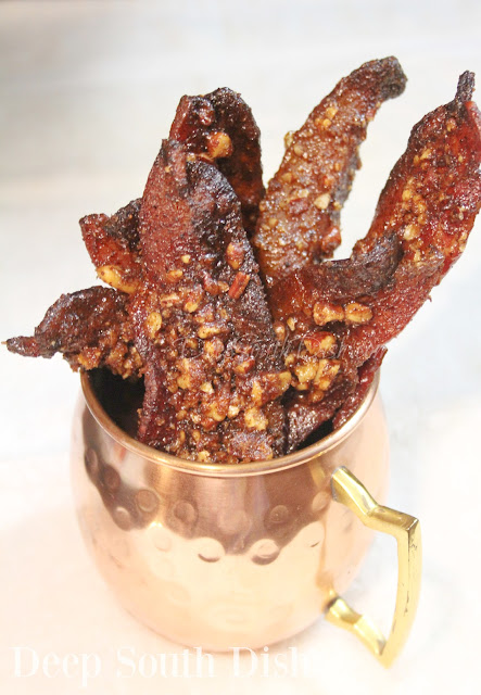 Bacon, tossed in a spicy brown sugar seasoning, sprinkled with chopped pecans and baked.