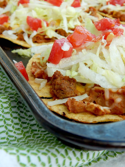 Oven Baked Tostadas...a simple, fun family meal!  Crunchy tostadas are layered with ground beef, refried beans and cheese and then topped with all the toppings! (sweetandsavoryfood.com)