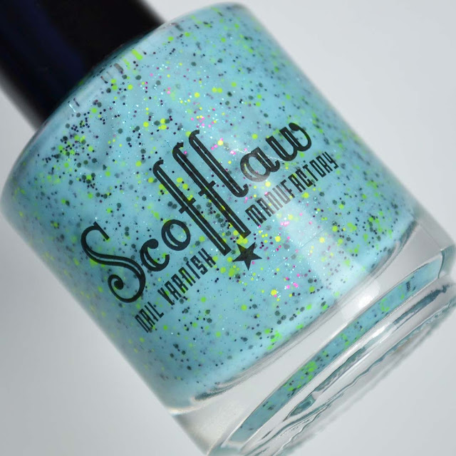 blue nail polish with glitter in a bottle