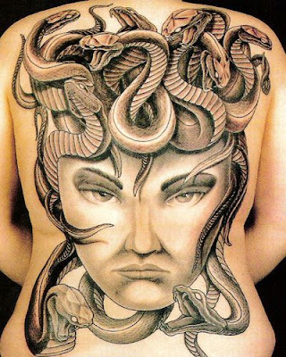 totem carver, heavily tattooed man, world traveler, circus performer, A full back tattoo design is always impressive because of its size,