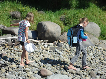 Nani and friend looking for things washed up on beach on a school field trip