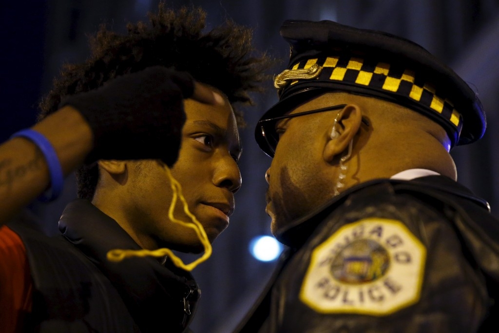 70 Of The Most Touching Photos Taken In 2015 - Protestors confront police during a demonstration in response to the fatal shooting of Laquan McDonald in Chicago, Illinois.