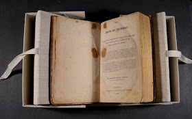 The Book of Mormon, open inside its case.