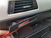 Removing cup holder trim with trim pulling tool