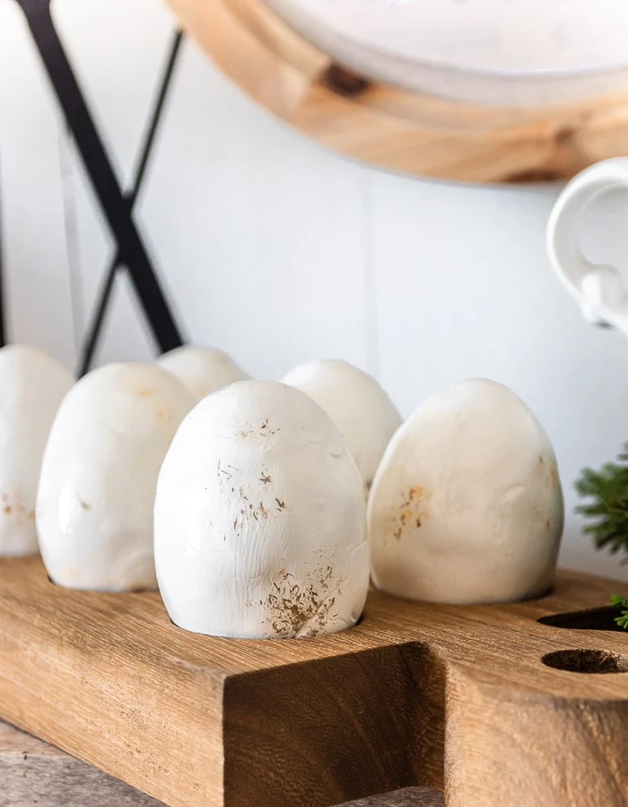 faux ironstone eggs in wood egg holder
