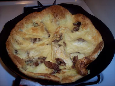 Puffed pear pancake in a skillet.