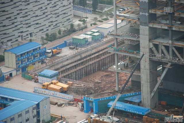 Photo of construction hole and construction trucks waiting on the street