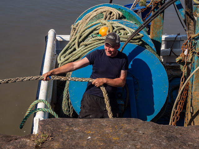 Photo of a fisherman at work on his boat