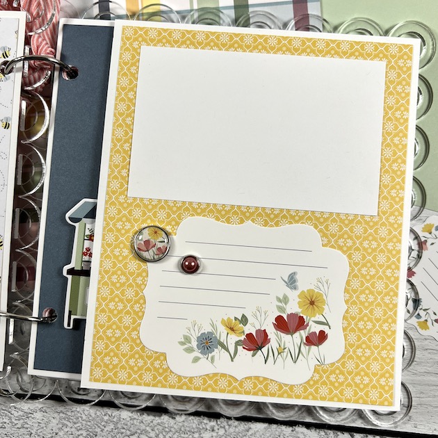 Spring scrapbook with flowers, enamel brads, & a scalloped acrylic album