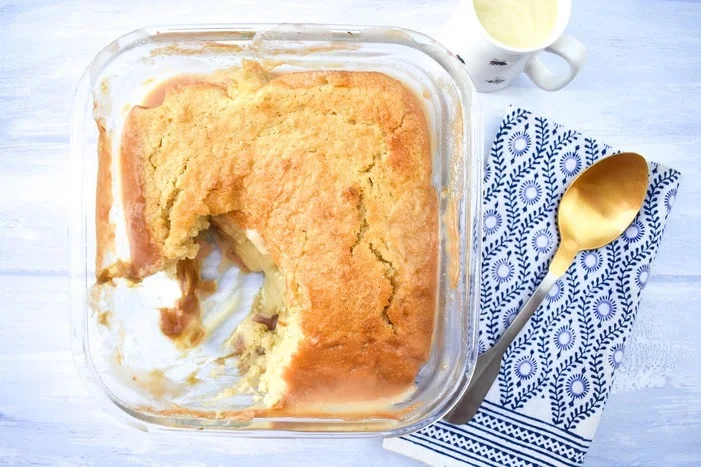 Vegan Rhubarb & Custard Sponge Pudding in a glass casserole dish