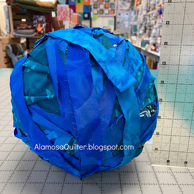 9 yards of 1" strips of fabric rolled into a ball