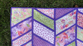 Split Arrows chevron baby quilt in pink and purple fabrics with minky backing