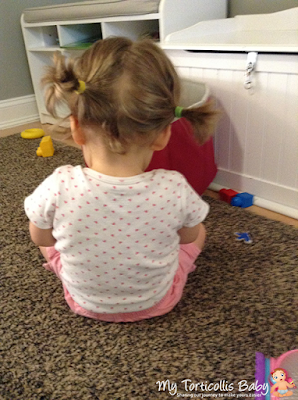 Toddler with mild torticollis sitting down