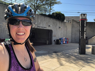 Photo of Jean in a bike helmet in front of the Forest Glen Metro station entrance