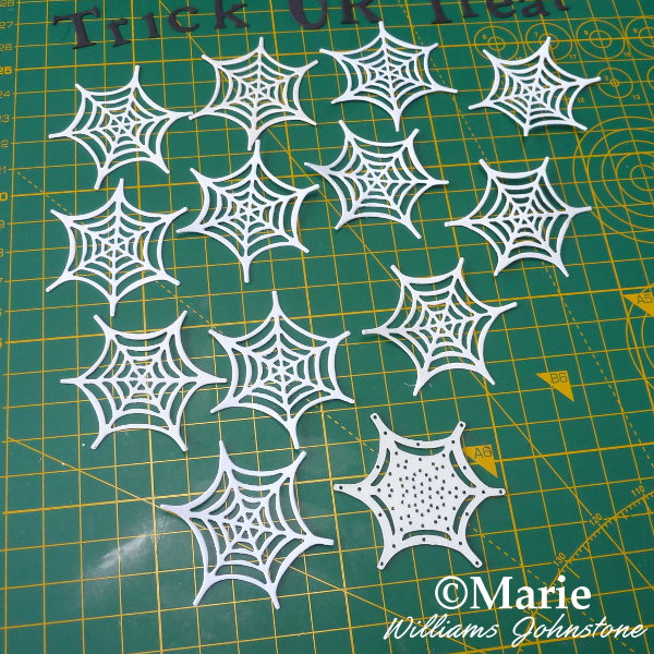 Die cutting Sizzix spider webs from white silver card paper for mini garland banner bunting