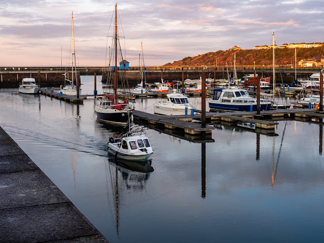 Photo of a fishing boat returning to Maryport Marina just before sunset