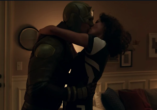 Matt Murdock in his full yellow and brown Daredevil costume and Jen in her supersuit aggressively making out.
