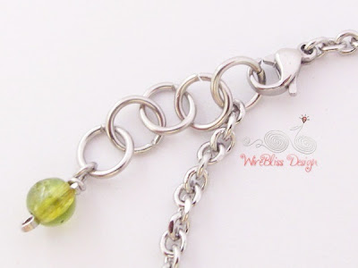 Close up of Peridot Charm and Clasp of Wire Wrapped Minima Bracelet (Minlet)