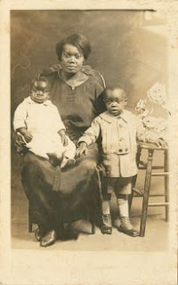 Seated Woman With Two Children