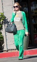 Paris Hilton wearing green sweatpants 