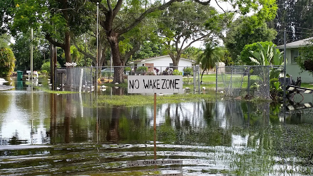 Eclectic Red Barn: No Wake sign in yard