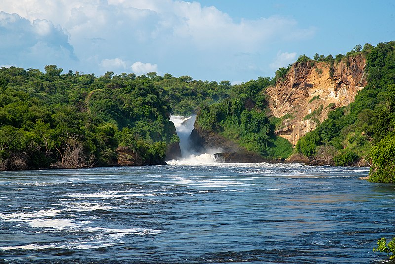 A scenic view of Murchison Falls against a clear blue sky flowing into the Victoria Nile downstream at Murchison Falls National Park, Masindi, Uganda on 12th June, 2022.